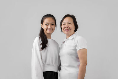 Portrait of a smiling young woman over white background