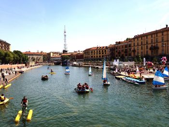 People enjoying rafting on river in city