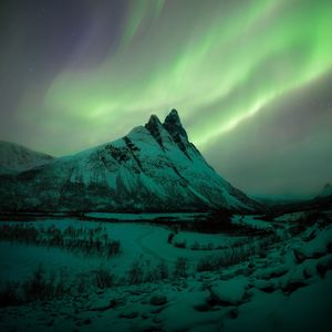 Scenic view of snowcapped mountains against sky at night