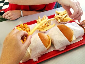 High angle view of burger with french fries on table