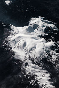 High angle view of snowcapped mountains and sea