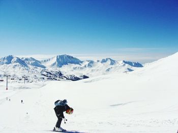 Tourists on snow covered mountain