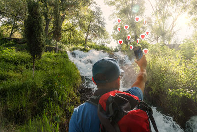 Rear view of man standing in forest
