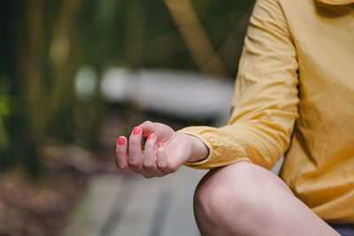 Midsection of woman holding hands
