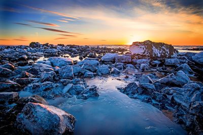 View of frozen sea during sunset