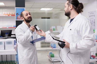 Female doctor examining chemical in laboratory