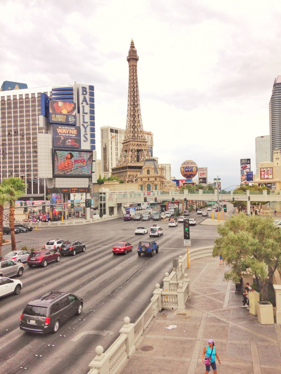 tower, architecture, built structure, tall - high, city, car, travel destinations, sky, transportation, building exterior, tourism, city life, land vehicle, travel, tall, day, outdoors, road, skyscraper, cityscape, no people