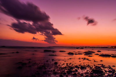 Scenic view of sea against romantic sky at sunset