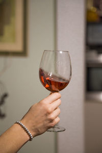 Female arm swirling a rose wine glass