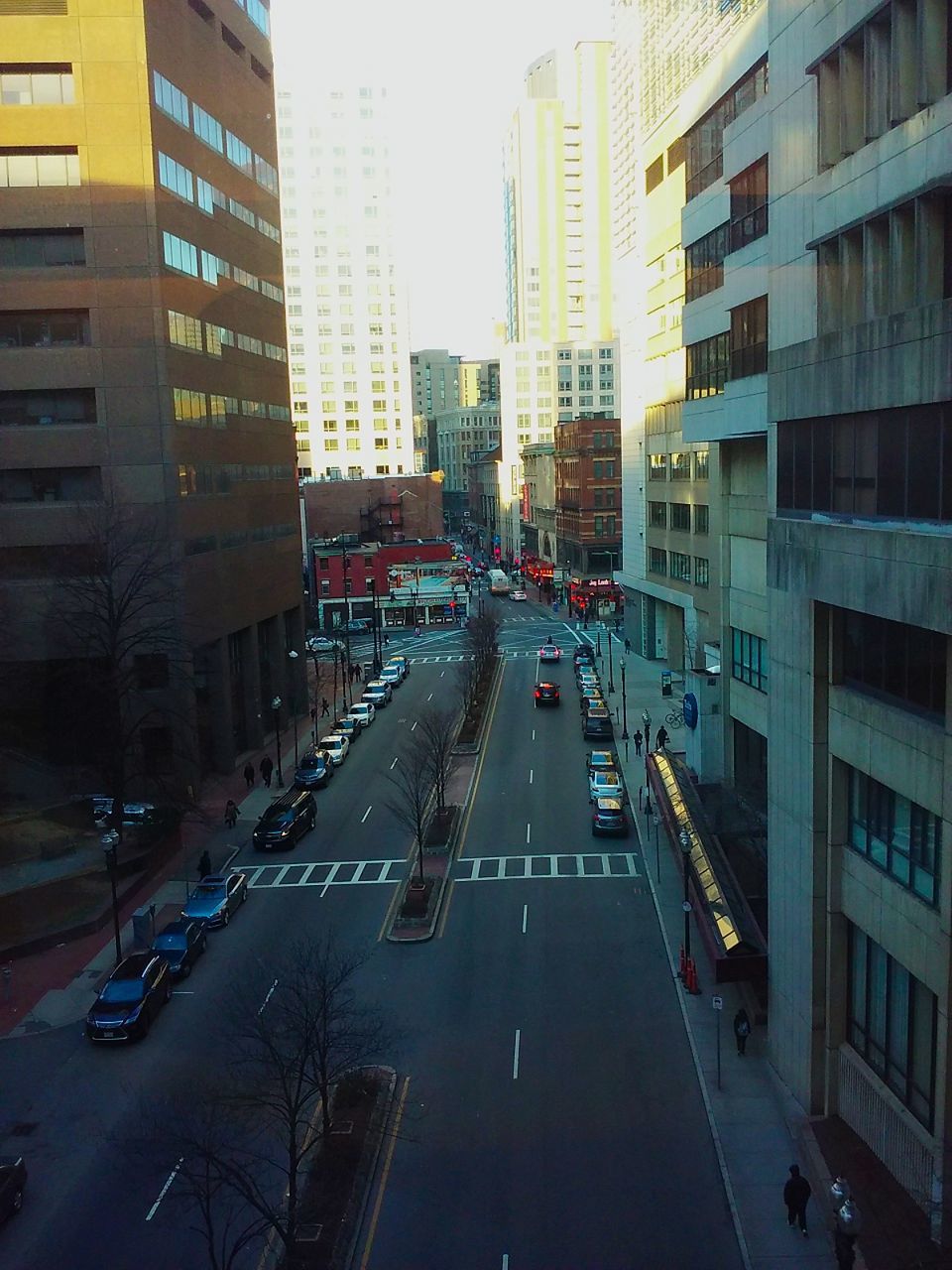 VEHICLES ON ROAD AGAINST BUILDINGS