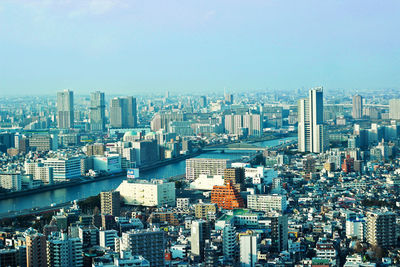 Aerial view of modern buildings in city against sky