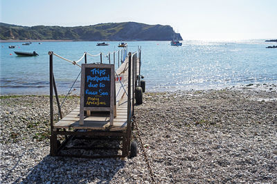 Lifeguard hut on beach against sky