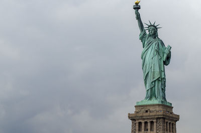 Low angle view of statue against cloudy sky