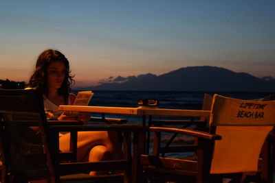 People sitting on mountain at sunset