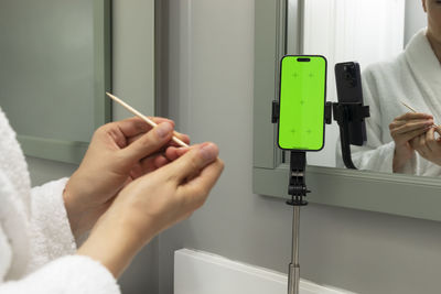 Cropped hand of man using mobile phone