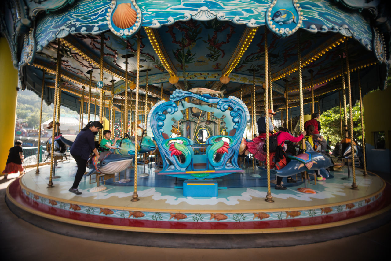 amusement park, amusement park ride, arts culture and entertainment, carousel, fairground ride, carousel horses, leisure activity, merry-go-round, animal representation, enjoyment, fun, outdoors, group of people, real people, day