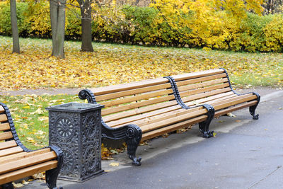 Empty bench in park during autumn