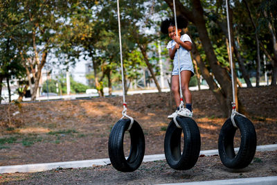 Full length of person on swing in playground