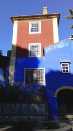 Low angle view of building against blue sky