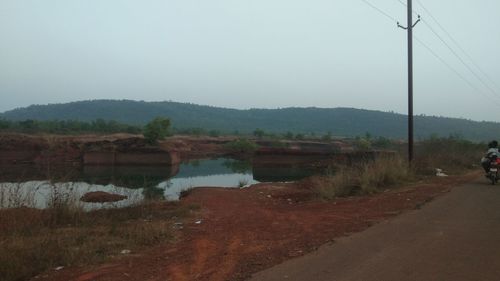 Scenic view of landscape against sky during rainy season