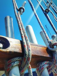 Low angle view of rope tied to metal