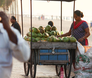 Woman selling coconut at market stall