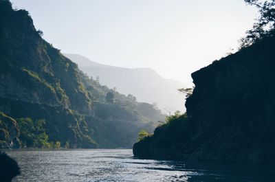 Scenic view of sea and mountains against sky