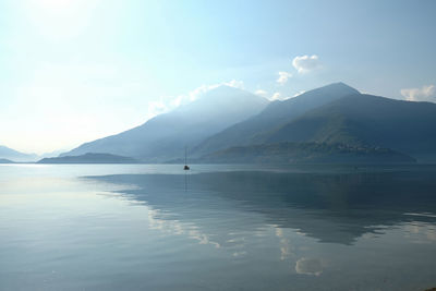 Scenic view of sea and mountains against sky