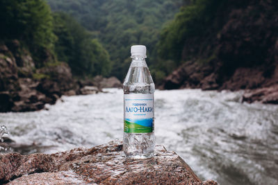 Close-up of water bottle on rock