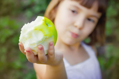 Close-up of boy eating apple