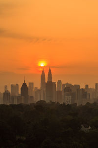 Buildings in city during sunset