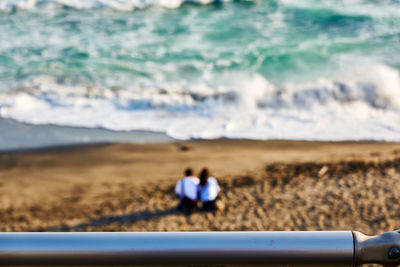 Rear view of people on beach