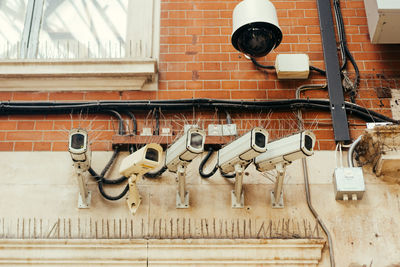 Low angle view of security cameras on wall