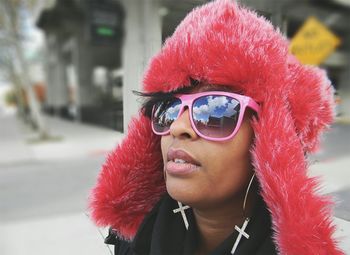 Close-up portrait of young woman wearing sunglasses