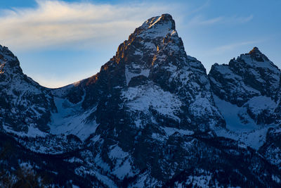 Scenic view of snowcapped mountains against sky. the central peak of the tetons. 