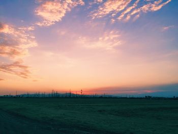 Scenic view of field against sky at sunset