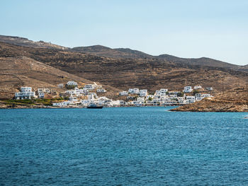 Scenic view of sea and buildings against clear sky