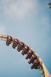 Low angle view of carousel against sky