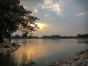 Scenic view of lake against sky at sunset