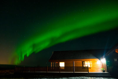 Illuminated building against sky at night