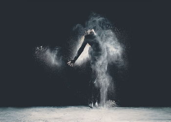 Studio shot of young woman dancing