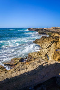 Scenic view of sea against clear blue sky