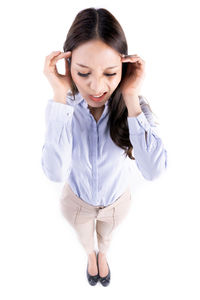 Young woman standing against white background