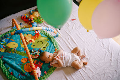 High angle view of cute baby sleeping on table