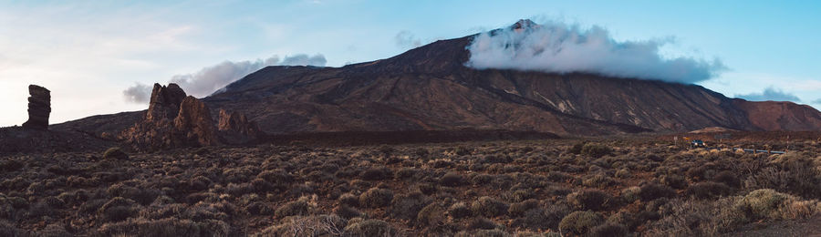 Panoramic view of arid landscape against sky