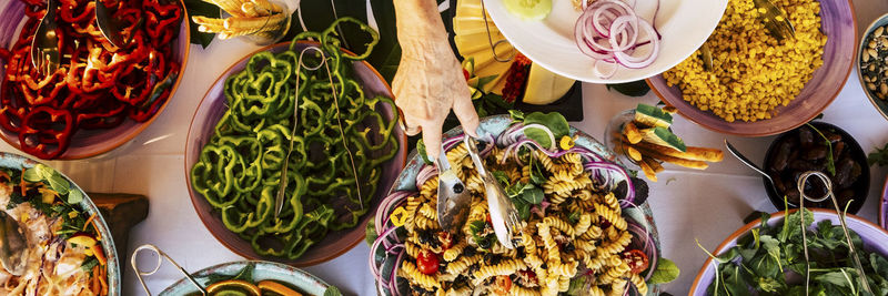 Woman serving pasta in plate at party