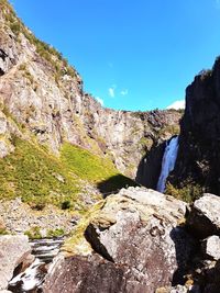 Scenic view of mountain against blue sky