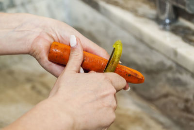 Close-up of hand holding orange