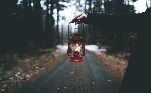 Cropped image of hand holding illuminated light bulb