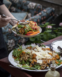 High angle view of person holding food on table